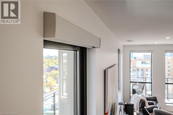 View from the living room looking out a large window with blinds. - 181 King Street S Unit# 1714, Waterloo