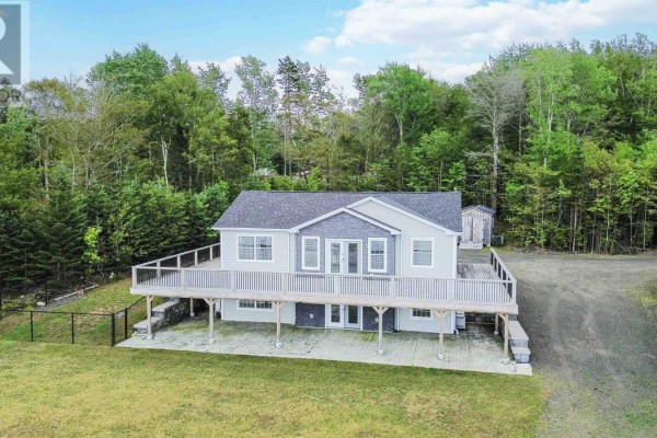 Lawn leading to waterfront with a wooden deck and tree - 181 Timberland Road, South Range