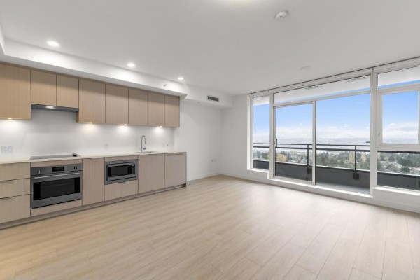 Contemporary kitchen with light wood cabinetry, stainless steel appliances, and large window overlooking the view. - 1810 13675 107a Avenue, Surrey