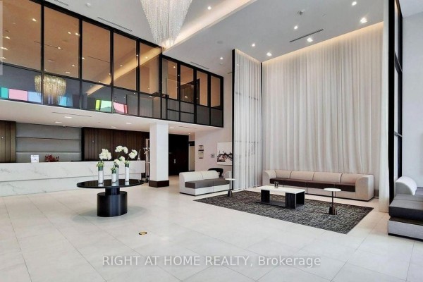 Luxurious condo lobby with marble floors, a reception desk, and seating areas. - 1812 - 38 Gandhi Lane, Markham