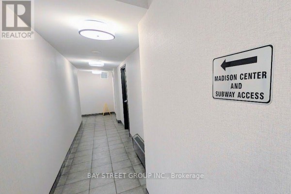 Hallway in apartment building with tile floor and sign pointing to subway. - 1812 - 4978 Yonge Street, Toronto