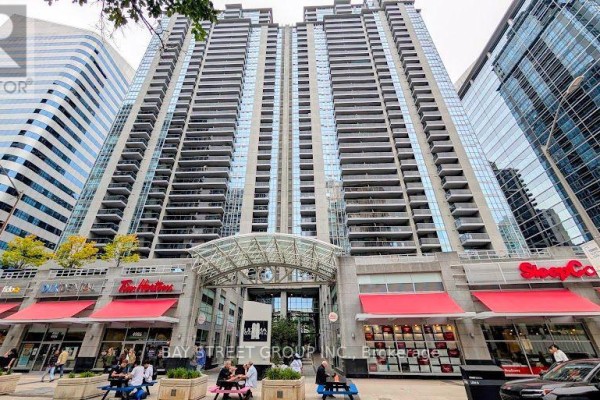 Exterior view of a tall condo building with shops at street level. - 1812 - 4978 Yonge Street, Toronto