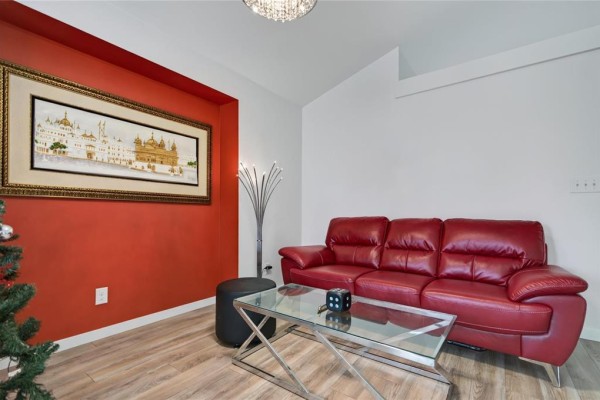 Modern kitchen with light wood cabinets, stainless steel appliances, and island. - 1813 Templeton Avenue, Winnipeg