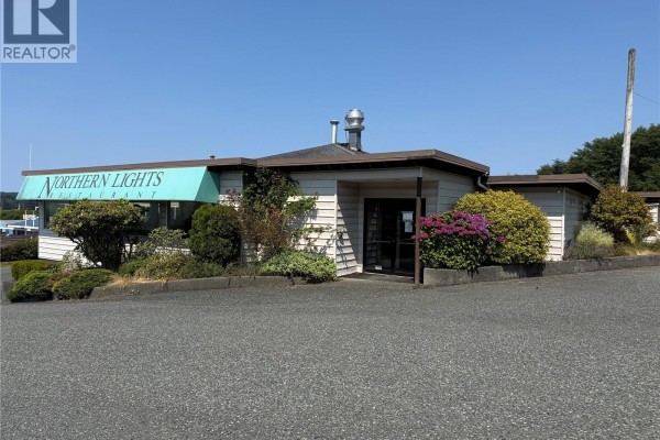 Front view of the Northern Lights Restaurant with a teal awning and surrounding shrubs. - 1817 Campbell Way, Port Mcneill