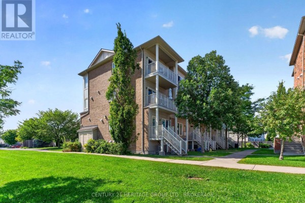 Aerial view of a condominium building with balconies and surrounding trees. - 182 - 150 Urbancrest Private, Ottawa