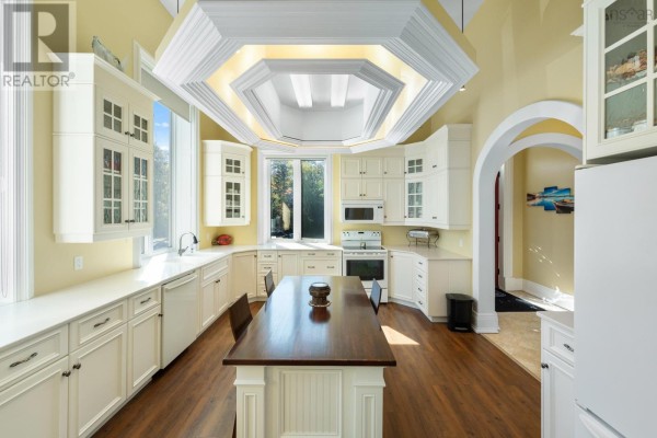 Spacious kitchen with cream cabinets, granite countertops, and a central island. - 1820 Culloden Road, Culloden