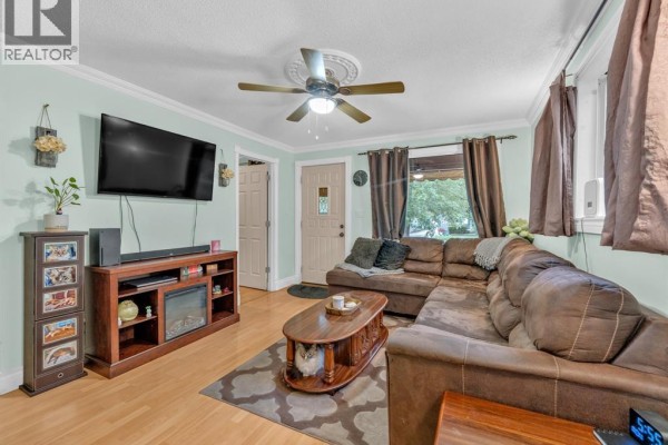 Living room interior with a brown sectional sofa, coffee table, and entertainment center. - 1826 Francois Road, Windsor