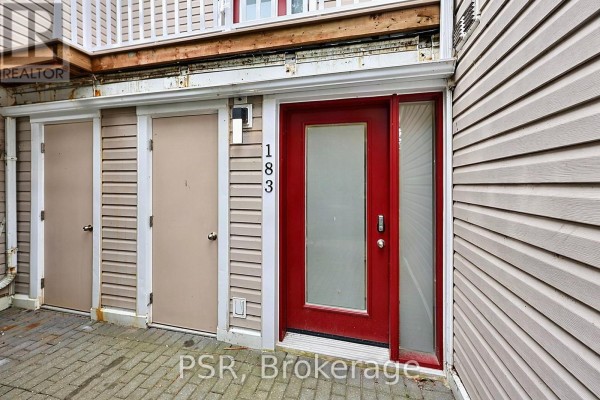 Exterior view of the front entrance and adjacent storage doors with brick paver walkway. - 183 - 49 Trott Boulevard, Collingwood