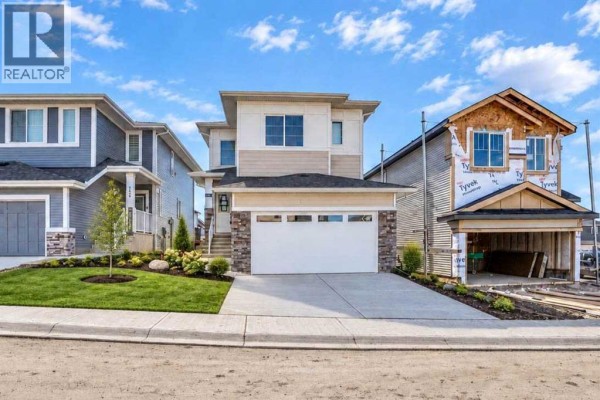 Floor plan of a two-story house showing layout of rooms, stairs, bathrooms, and laundry. - 183 Heritage Court, Cochrane