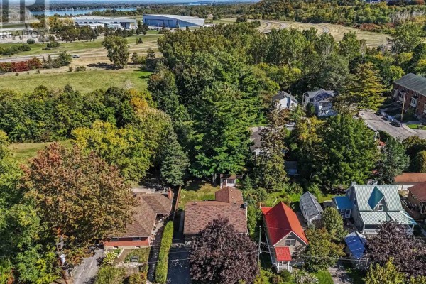 Aerial view of suburban homes surrounded by mature trees with a distant body of water. - 183 Martin Avenue, Ottawa