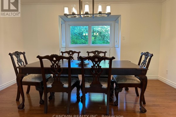 Living room with dark leather sofas, glass coffee table, and a digital piano. - 183 St. Anthony's Court, Richmond Hill