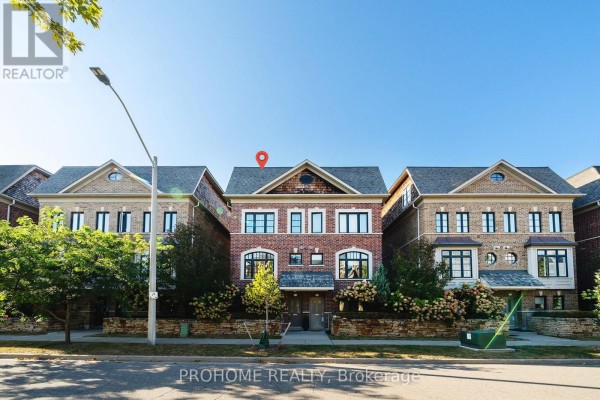 Street view of a row of brick townhouses with manicured bushes. - 1831 Pagehurst Avenue, Mississauga