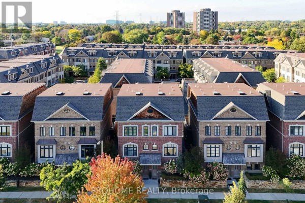 Aerial view of a townhouse development with red brick facades and gabled roofs. - 1831 Pagehurst Avenue, Mississauga