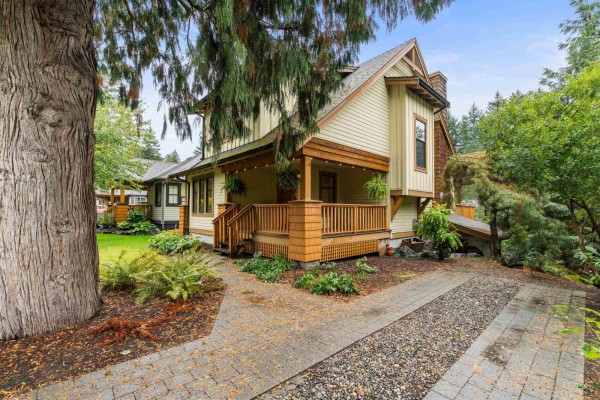 Side view of the house showing the entrance porch and driveway. - 1832 Huckleberry Bend, Cultus Lake South, Cultus Lake