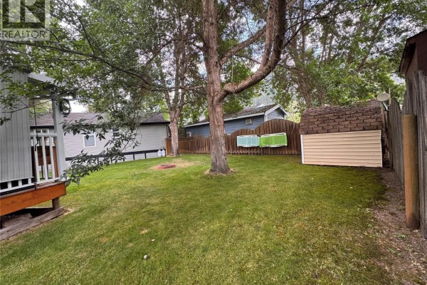 Backyard area with lawn chairs, fire pit, and wooden deck - 1835 Bakery Frontage Road Unit# 125 & 126, Christina Lake