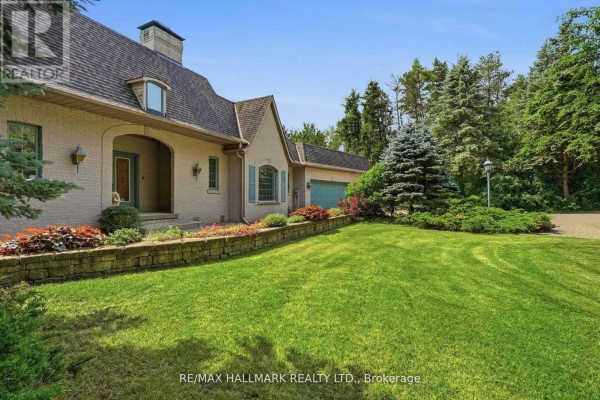 Spacious, bright foyer with a raised wooden platform, two chairs, and double glass doors. - 18381 Mccowan Road, East Gwillimbury