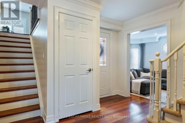 Interior view of the entrance hall with a staircase and doors to other rooms. - 1839 Fellen Place, Mississauga