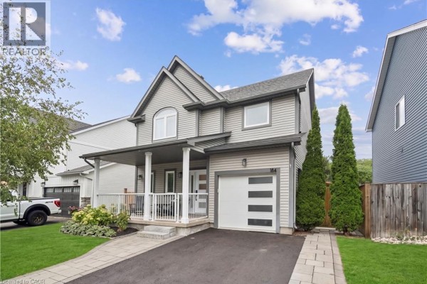 Exterior view of a grey siding two-story house with a manicured lawn and trees. - 184 Dunbar Street, Rockwood