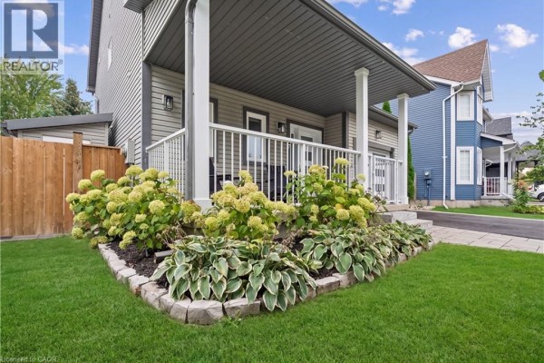 Close-up of the front porch garden with hostas and hydrangeas on a grey house. - 184 Dunbar Street, Rockwood