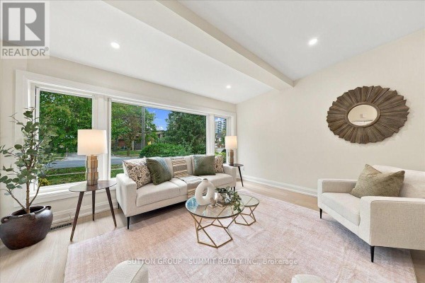 Living room featuring a large picture window with a view of trees and modern furniture. - 184 Torresdale Avenue, Toronto