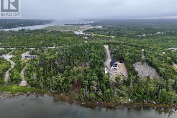 Aerial perspective of the lot with water views and dense tree coverage. - 184 Westside Inlet Drive, West Petpeswick