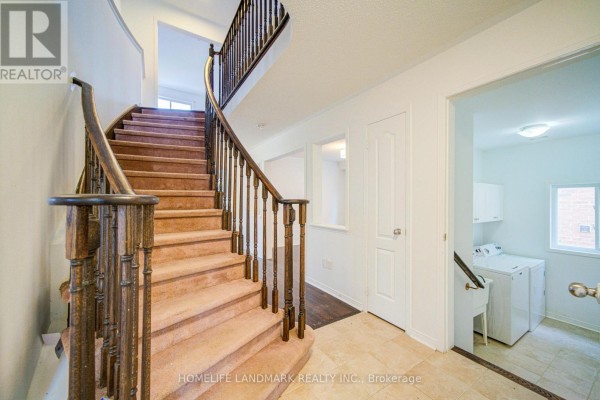 Living area with carpet flooring, columns, and natural light from windows - 1842 Esterbrook Drive, Oshawa