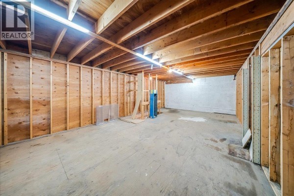 Concrete foundation walls and wood-paneled partitions creating separate areas within the commercial space. - 1846 First Street, Fruitvale