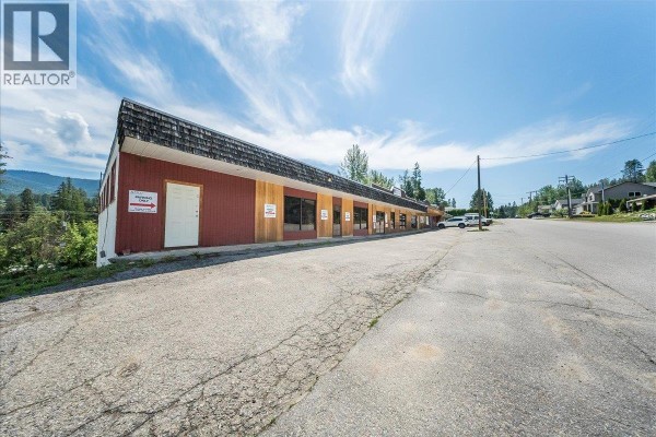 Exterior view of a one-story commercial building with a wood-shingled roof and multiple storefronts. - 1846 First Street, Fruitvale