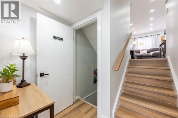 View of a staircase leading down to a living area, with a door labeled 'PRIVATE' on the side. - 185 Highland Crescent Unit# 2, Kitchener