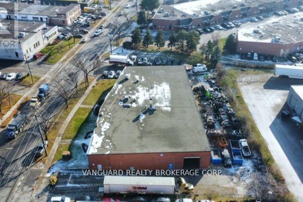 Aerial view of the commercial property, highlighting the building's footprint and surrounding industrial park landscape. - 185 Toryork Drive, Toronto