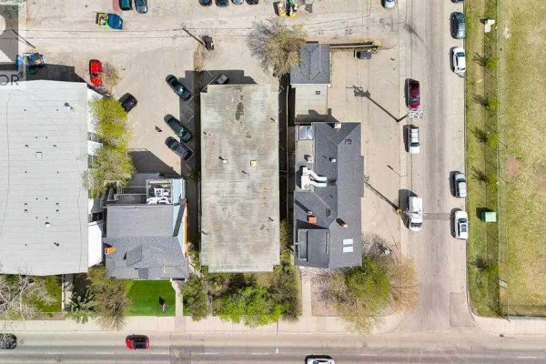 Top-down aerial view of urban buildings, parking lots, and streets. - 1850 14 Street Sw, Calgary