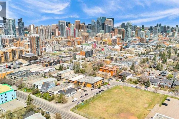 Distant view of the Calgary skyline and urban neighborhood from above. - 1850 14 Street Sw, Calgary