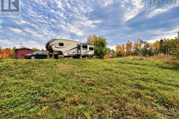 RV and red shed on grassy knoll with autumn trees. - 1852 River John Road, River John