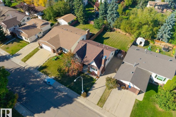 Overhead aerial view of a residential street showing multiple houses with manicured lawns and garages. - 18528 98 Av Nw, Edmonton