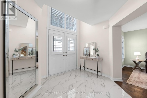 Bathroom with a white toilet, tiled shower stall with glass door, and plantation shutters on the window. - 1856 Rosebank Road, Pickering