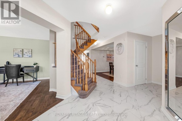 Office or sitting room with two upholstered chairs, a desk, bay windows with white shutters, and hardwood floors. - 1856 Rosebank Road, Pickering