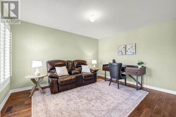 Kitchen with dark wood cabinets, white quartz countertops, stainless steel appliances, and marble-look tile flooring. - 1856 Rosebank Road, Pickering