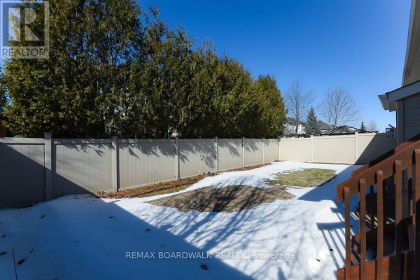 Backyard with privacy fence, paved patio, wooden deck stairs - 1861 Mickelberry Crescent, Ottawa