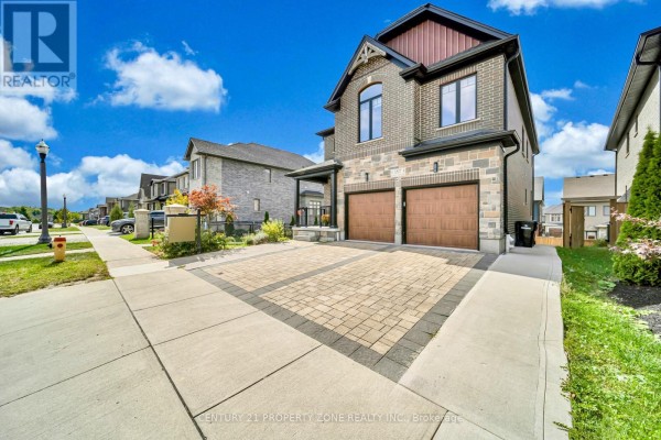 Two-storey detached house with brick and stone exterior and a double garage. - 187 Forest Creek Drive, Kitchener