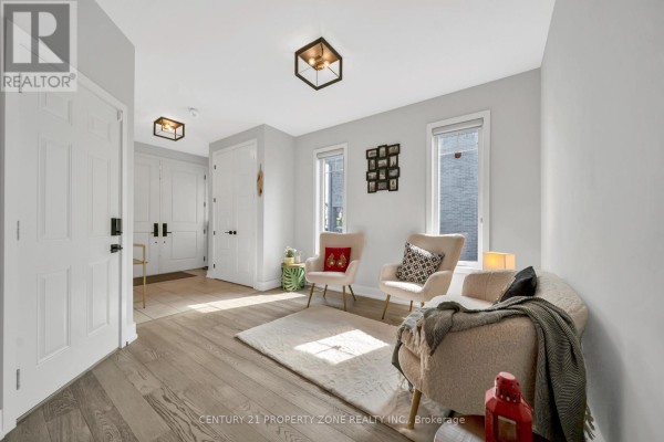 Interior foyer with tiled floor and double white doors at the end of the hallway. - 187 Forest Creek Drive, Kitchener