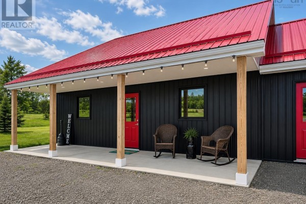 Side view of the black building with red roof and single garage door. - 1874 Brow Of Mountain Road W, Viewmount