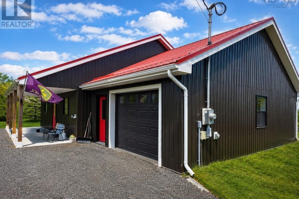 Back of the house with covered patio, propane tanks, and green grass. - 1874 Brow Of Mountain Road W, Viewmount