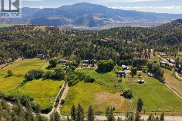 Overhead view of property showing house, barn, gardens, and surrounding trees. - 1876 Willowbrook Road, Oliver