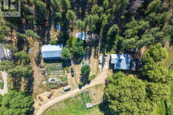 Aerial view of 1876 Willowbrook Road property with surrounding fields, trees, and rural landscape. - 1876 Willowbrook Road, Oliver