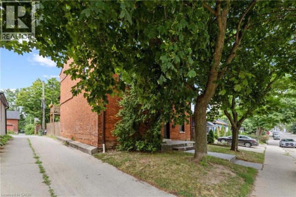 Bedroom with a double bed, white double doors, and eclectic decor. - 188-190 Caroline Street S, Hamilton