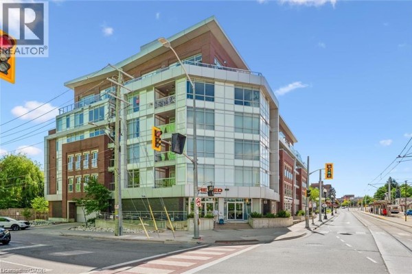 Corner view of the apartment building showing multiple balconies and the main entrance. - 188 King Street S Unit# 304, Waterloo