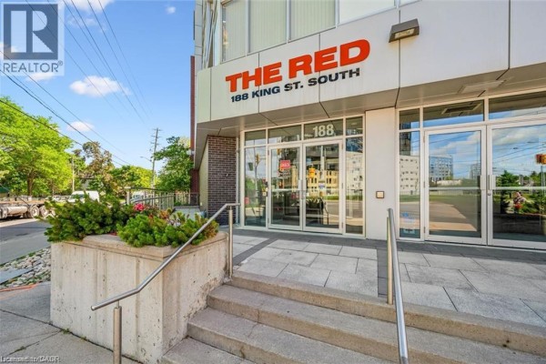 Close-up of the building's main entrance with "THE RED 188 KING ST. SOUTH" signage. - 188 King Street S Unit# 304, Waterloo
