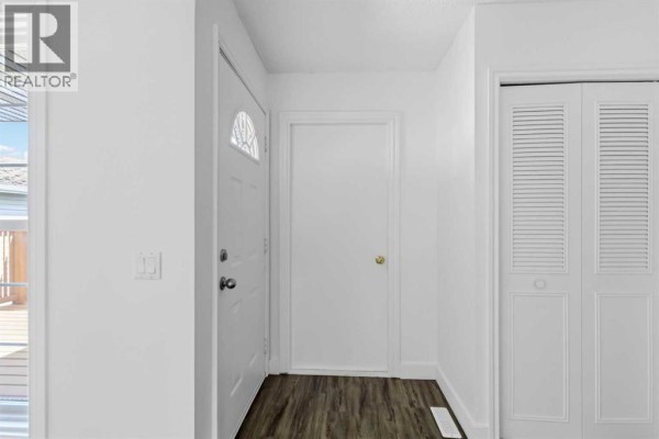 Interior front entryway with white walls, a white front door, and a closet. - 188 Windsor Drive, Fort Mcmurray