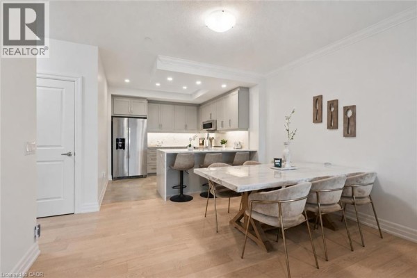 Dining area adjacent to the kitchen and a view of the living room. - 1880 Gordon Street Unit# 707, Guelph