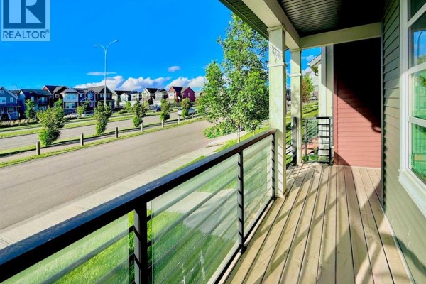 Front view of duplexes showcasing entrance steps and snow-covered ground - 189 Carringvue Way Nw, Calgary